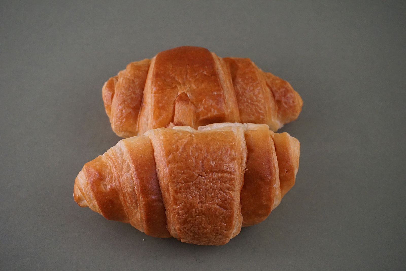 Fresh croissants at a Paris boulangerie counter, one of the first things to do in Paris each morning