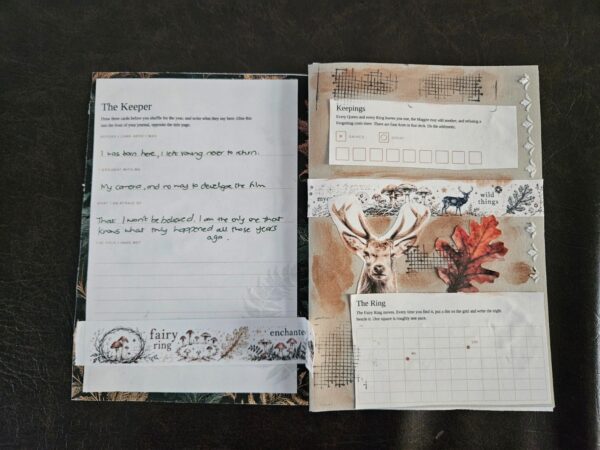 A Folklore Forest journal open to the first played spread